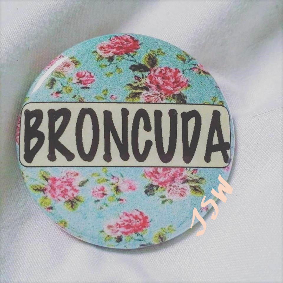 BRONCUDA Flower PIN BUTTON black font on blue and pink flowers 1.5"