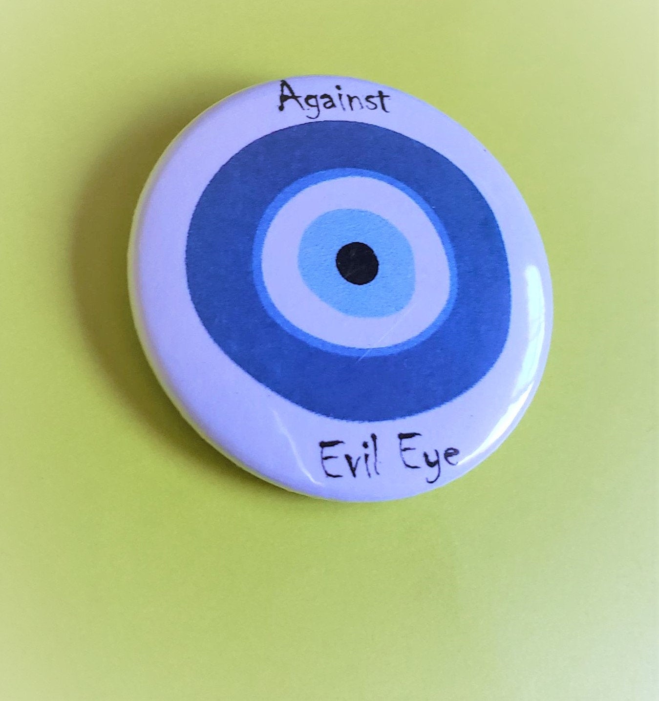 AGAINST EVIL EYE PIn Button 1.5"