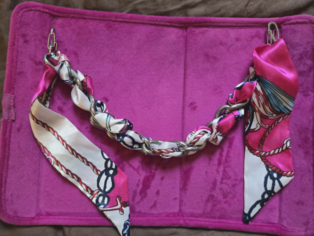 Decorative chain with a colorful pattern on a pink surface