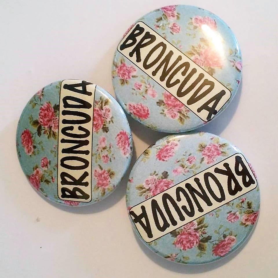 BRONCUDA Flower PIN BUTTON black font on blue and pink flowers 1.5"
